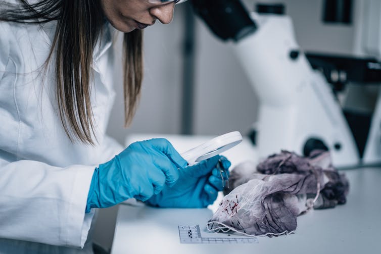 Forensic scientist in lab.