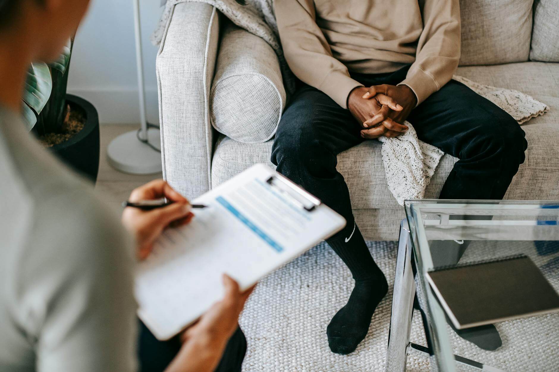 Pexels photo 5699431 simplyforensic crop ethnic client discussing problems with anonymous psychologist