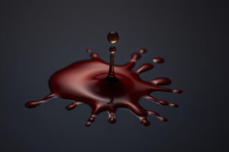 A close up view of the biomechanics of bloodstain formation on a smooth dark surface Capture A close up view of the biomechanics of bloodstain formation on a smooth dark surface Capture the intricate patterns and flow dynamics as a droplet of crimson liquid impacts and spreads out revealing the underlying physics Utilize a high resolution macro lens to render the textures and viscosity of the blood in vivid detail Employ dramatic side lighting to accentuate the contours and shadows conveying the scientific nature of the subject matter The overall tone should be clinical yet captivating inviting the viewer to explore the fascinating interplay of physics and forensics Simplyforensic